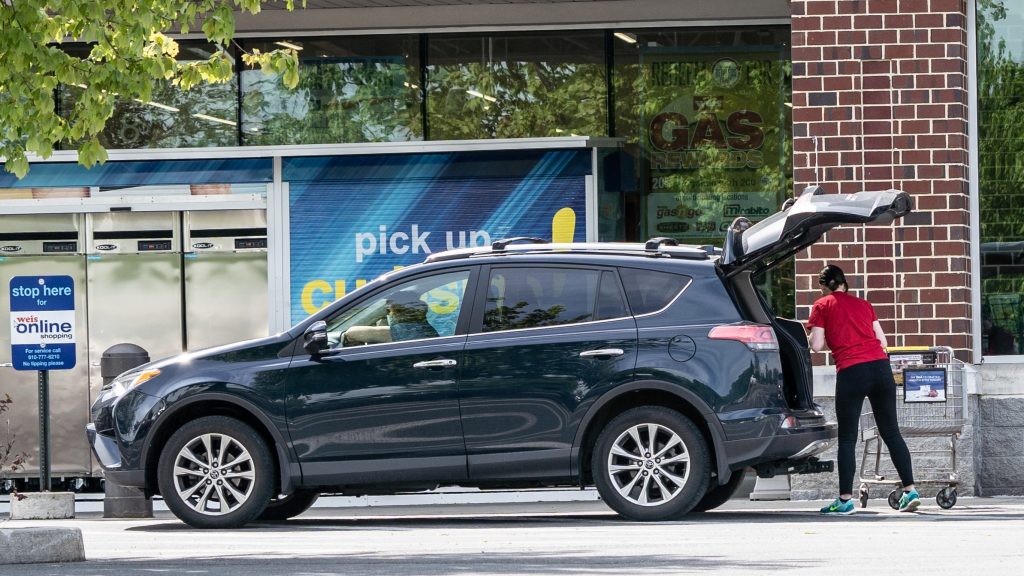 Curbside Employee Puts Groceries in Car