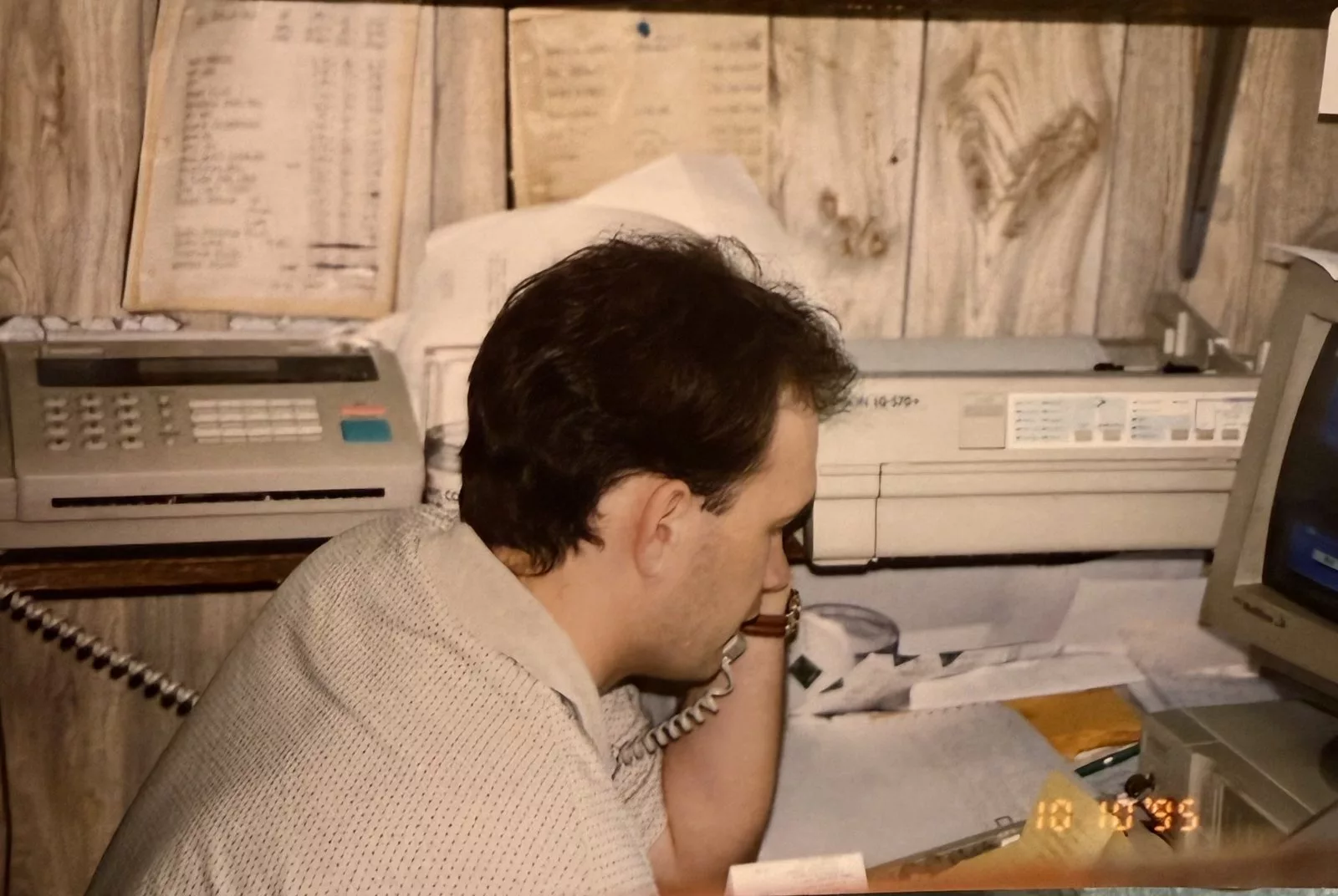 Our founder in the store back office in 1995, working the phones between a fax machine and a dot-matrix printer